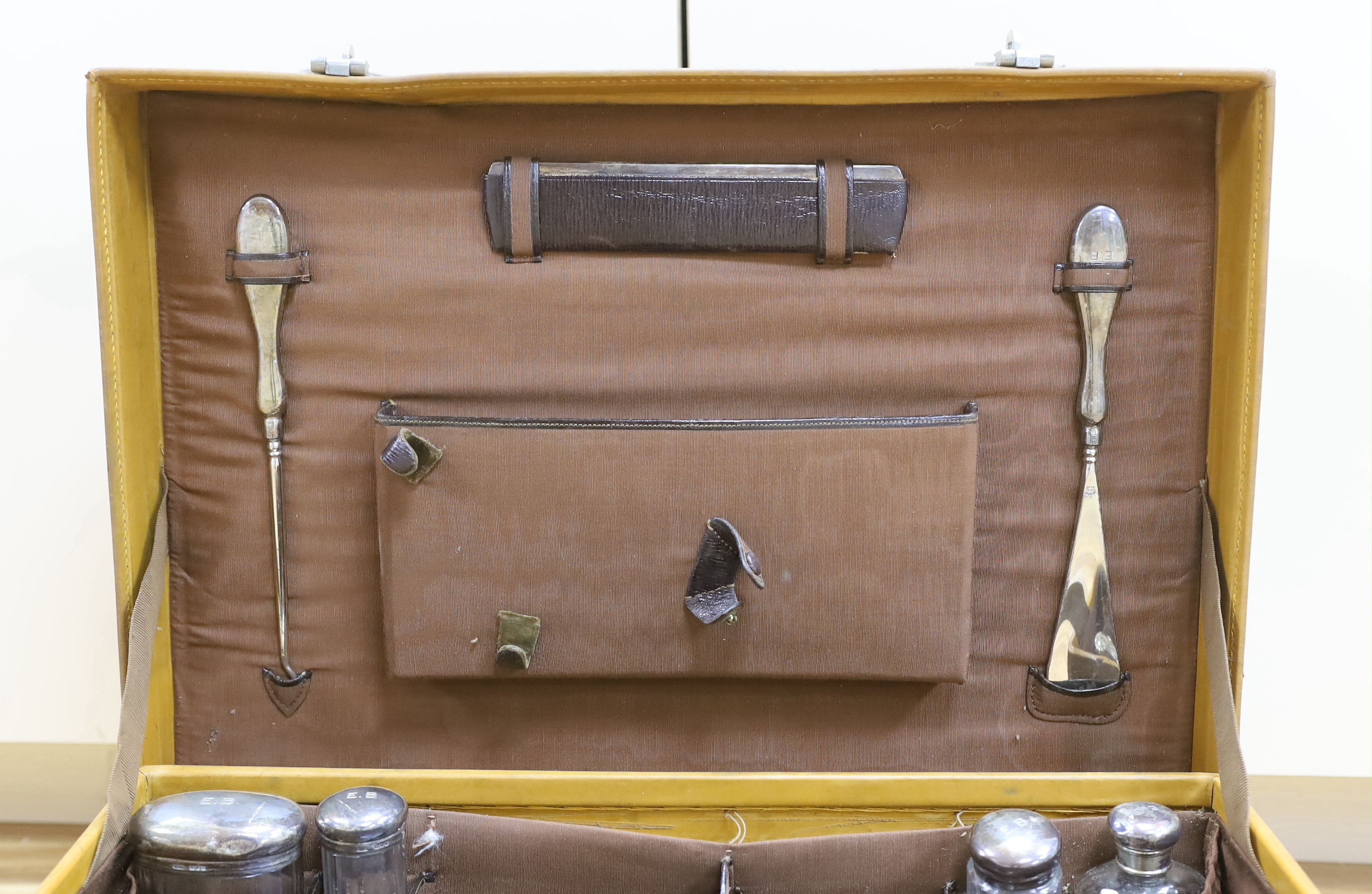 A vintage Mappin and Webb vanity case with five silver mounted bottles and shaving kit 51cm wide